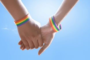 Hands with rainbow bracelets